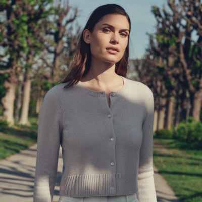 Woman wearing a N.Peal cardigan in a park setting